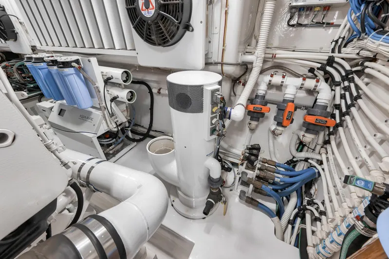 Makara Yacht Photos Pics Engine room of 2018 Viking 72 Sky Bridge yacht with complex piping and filtration systems.