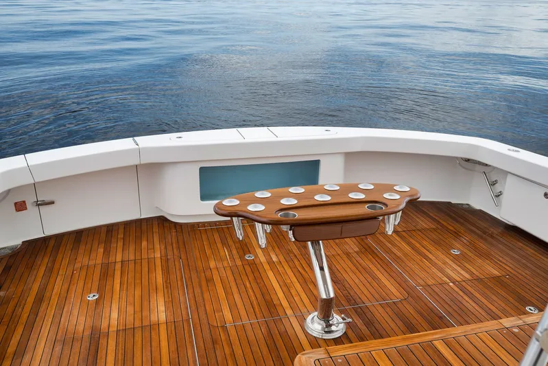 Makara Yacht Photos Pics Luxury teak deck of 2018 Viking 72 Sky Bridge yacht, featuring a stylish fishing station.