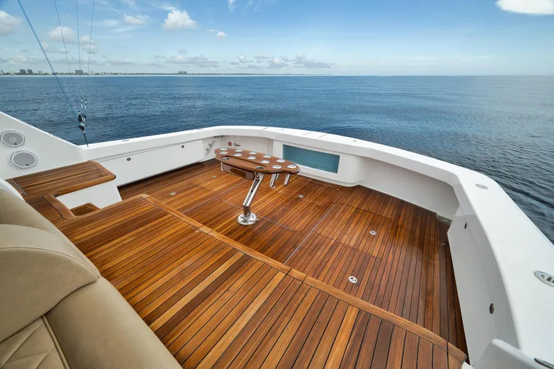 Makara Yacht Photos Pics Luxurious 2018 Viking 72 Sky Bridge yacht with teak deck overlooking serene ocean.