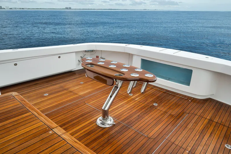 Makara Yacht Photos Pics Luxurious 2018 Viking 72 Sky Bridge yacht deck with wooden flooring and ocean view.