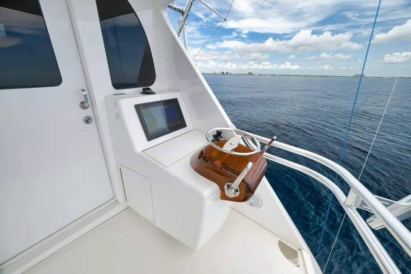 Makara Yacht Photos Pics 2018 Viking 72 Sky Bridge helm with ocean view and navigation display.