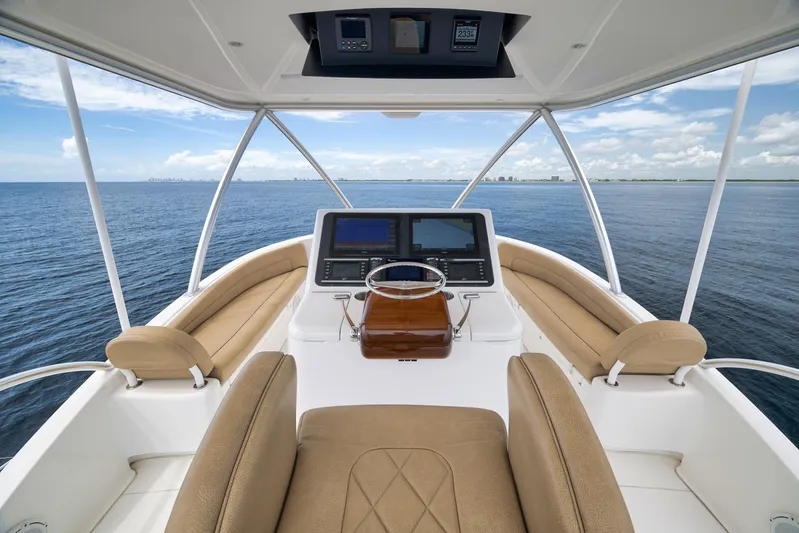 Makara Yacht Photos Pics Helm of 2018 Viking 72 Sky Bridge yacht with ocean view and navigation equipment.