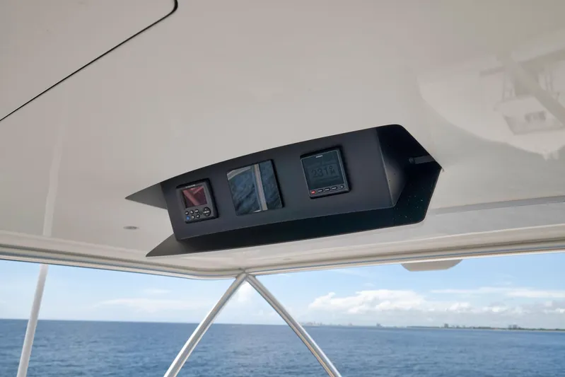 Makara Yacht Photos Pics Control panel on 2018 Viking 72 Sky Bridge yacht, overlooking ocean horizon.