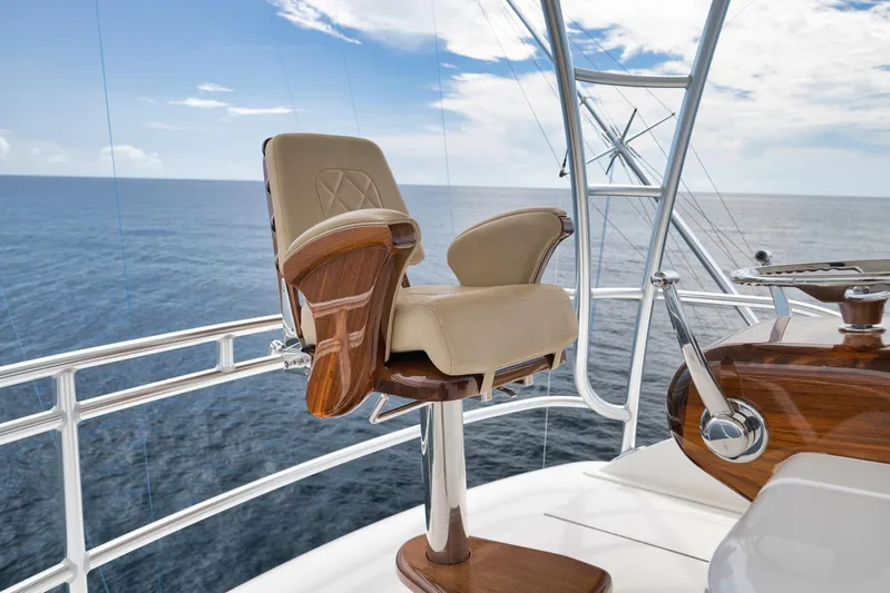Makara Yacht Photos Pics Luxurious helm chair on 2018 Viking 72 Sky Bridge yacht, overlooking the ocean.
