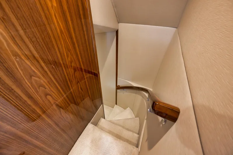 Makara Yacht Photos Pics Staircase with wooden paneling inside 2018 Viking 72 Sky Bridge yacht.