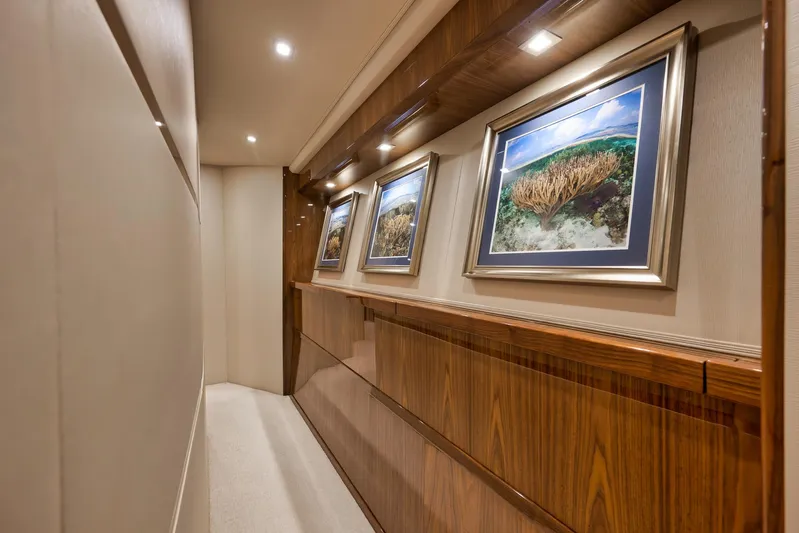 Makara Yacht Photos Pics Luxurious hallway in 2018 Viking 72 Sky Bridge yacht with framed ocean artwork.