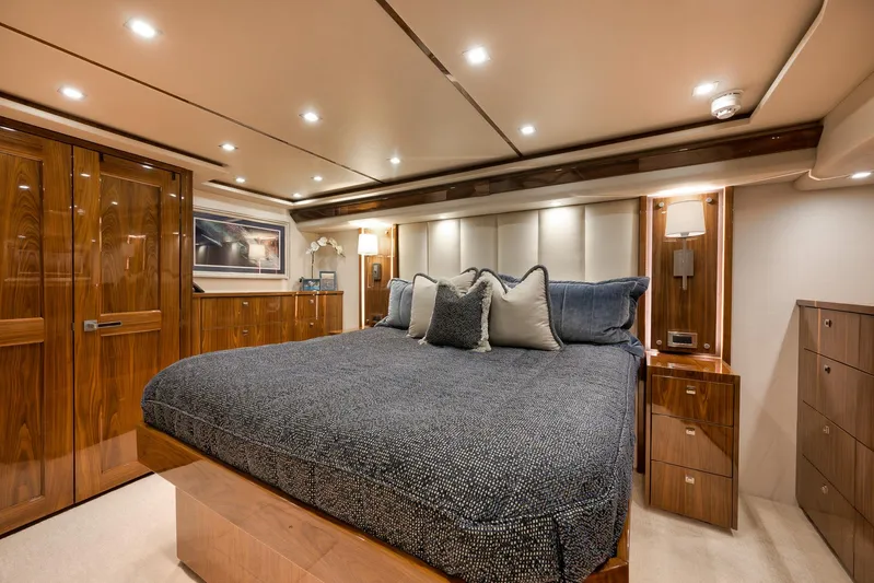 Makara Yacht Photos Pics Luxurious bedroom interior of 2018 Viking 72 Sky Bridge yacht with elegant wood finishes.