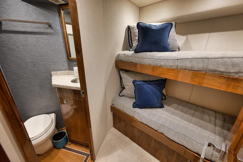 Makara Yacht Photos Pics Bunk beds and bathroom in 2018 Viking 72 Sky Bridge yacht interior.