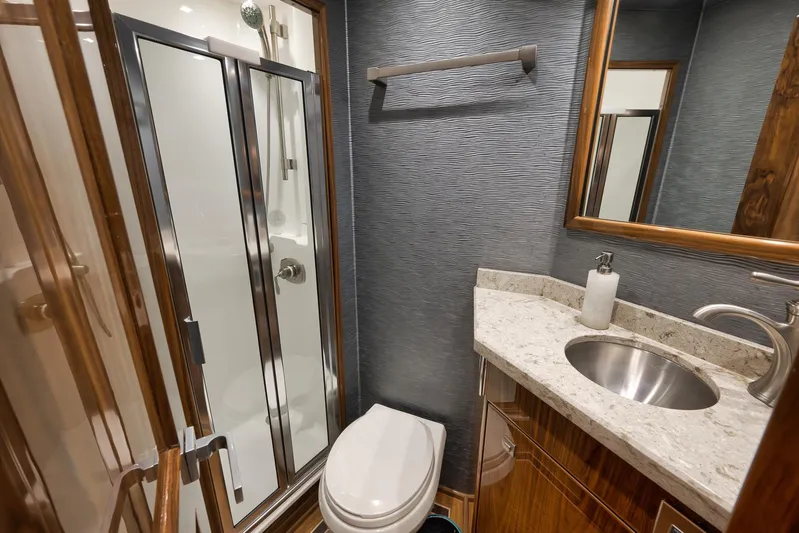 Makara Yacht Photos Pics Luxurious bathroom in 2018 Viking 72 Sky Bridge yacht with modern fixtures and elegant design.