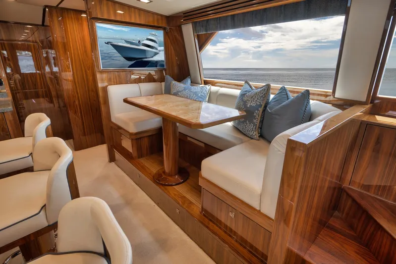 Makara Yacht Photos Pics Luxurious interior of 2018 Viking 72 Sky Bridge yacht with elegant seating and ocean view.