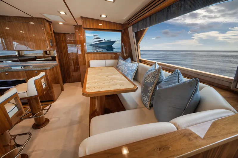 Makara Yacht Photos Pics Luxurious interior of 2018 Viking 72 Sky Bridge yacht with ocean view and elegant seating.