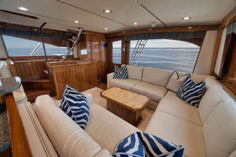 Makara Yacht Photos Pics Luxurious interior of 2018 Viking 72 Sky Bridge yacht with ocean view and elegant seating.