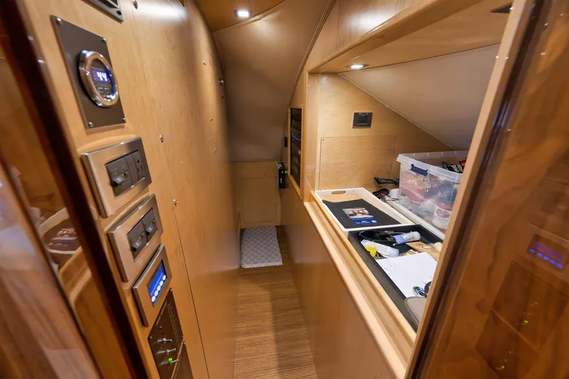 Makara Yacht Photos Pics Interior of 2018 Viking 72 Sky Bridge yacht with control panels and storage area.