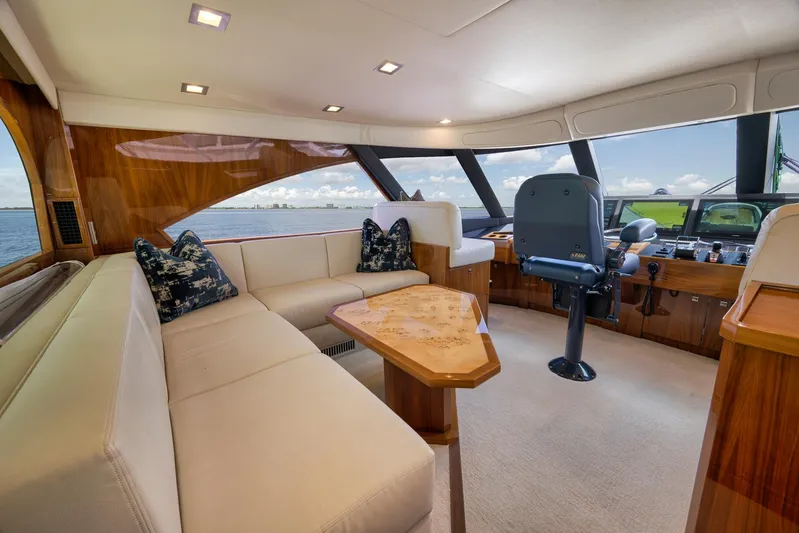 Makara Yacht Photos Pics Luxurious interior of 2018 Viking 72 Sky Bridge yacht with plush seating and modern helm.