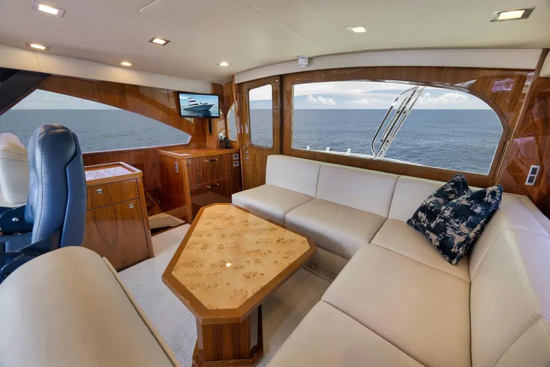 Makara Yacht Photos Pics Luxurious interior of 2018 Viking 72 Sky Bridge yacht with ocean view and elegant furnishings.