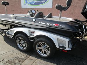 2024 Ranger Z519 Ranger Cup Equipped boat with dual axle trailer, parked outdoors.