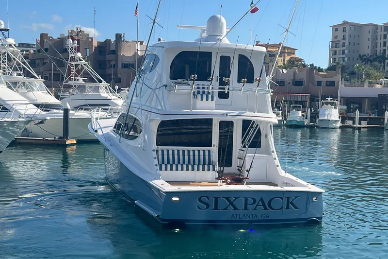 Sixpack Yacht Photos Pics 2013 Hatteras GT63 yacht "Sixpack" docked in a marina with other boats.
