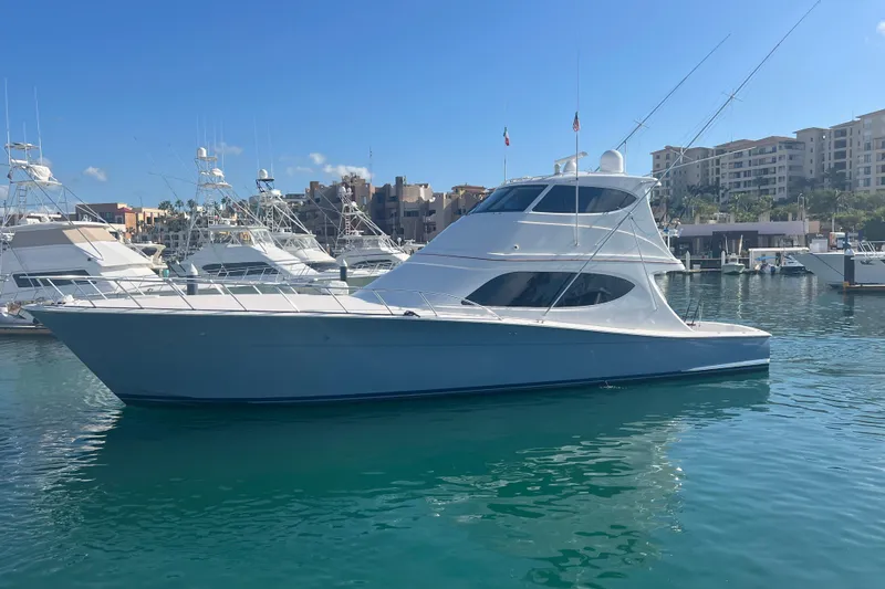 Sixpack Yacht Photos Pics 2013 Hatteras GT63 yacht docked in a marina under clear blue skies.