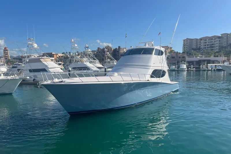 Sixpack Yacht Photos Pics 2013 Hatteras GT63 yacht docked in a marina under clear blue skies.