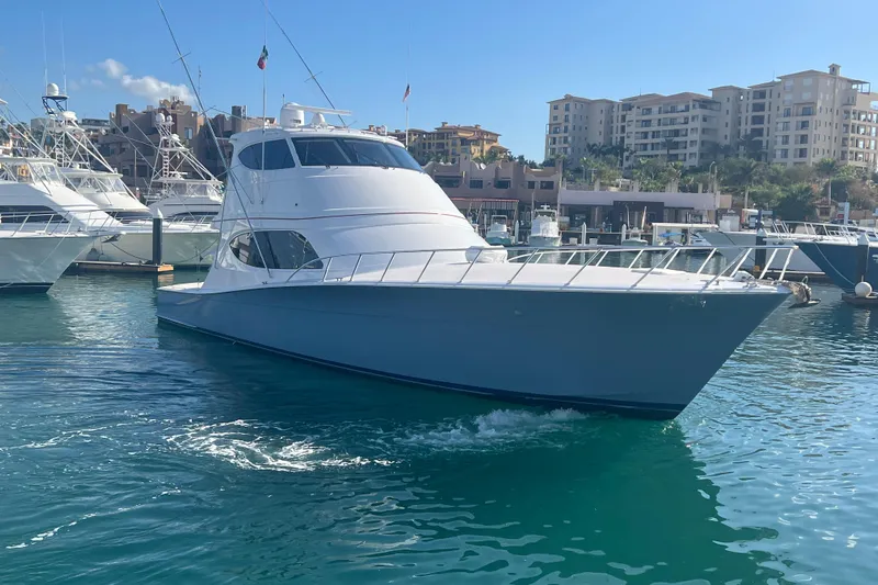 Sixpack Yacht Photos Pics 2013 Hatteras GT63 yacht docked in a marina with clear blue water.