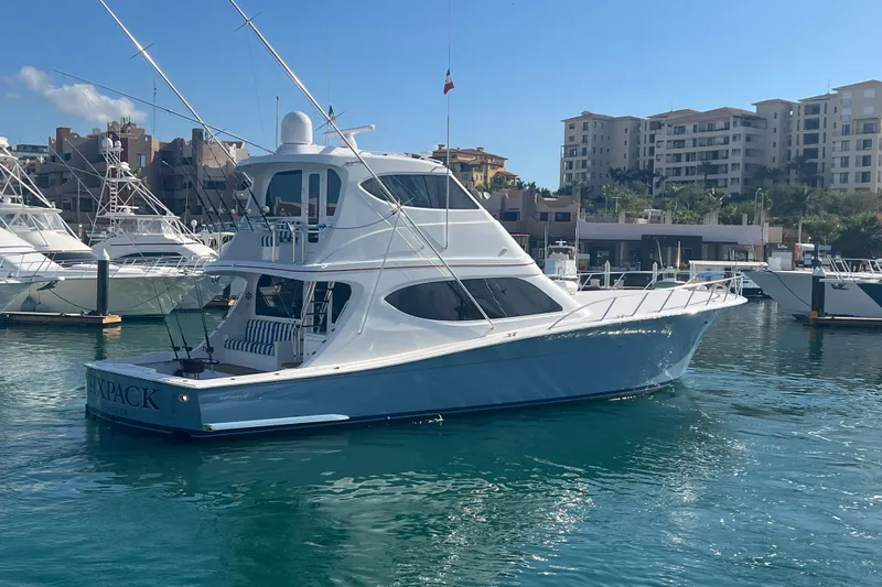 Sixpack Yacht Photos Pics 2013 Hatteras GT63 yacht docked in marina, clear blue water, sunny day.