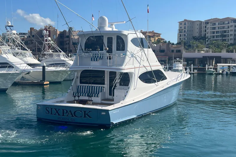 Sixpack Yacht Photos Pics 2013 Hatteras GT63 yacht "Sixpack" docked in a marina with clear blue water.