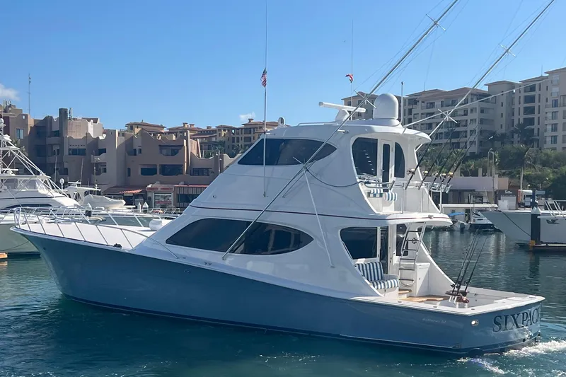 Sixpack Yacht Photos Pics 2013 Hatteras GT63 yacht docked in a marina with buildings in the background.