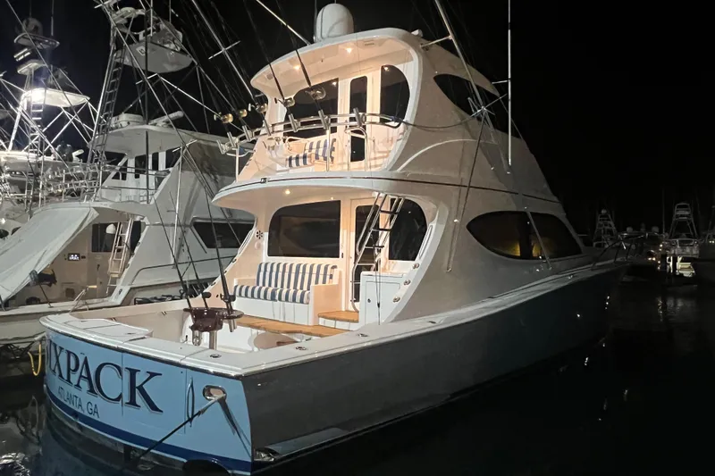 Sixpack Yacht Photos Pics 2013 Hatteras GT63 yacht docked at night, illuminated, with multiple decks.