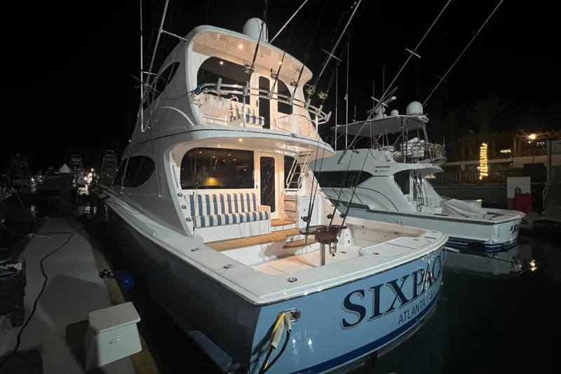 Sixpack Yacht Photos Pics 2013 Hatteras GT63 yacht docked at night, featuring a spacious deck and elegant design.