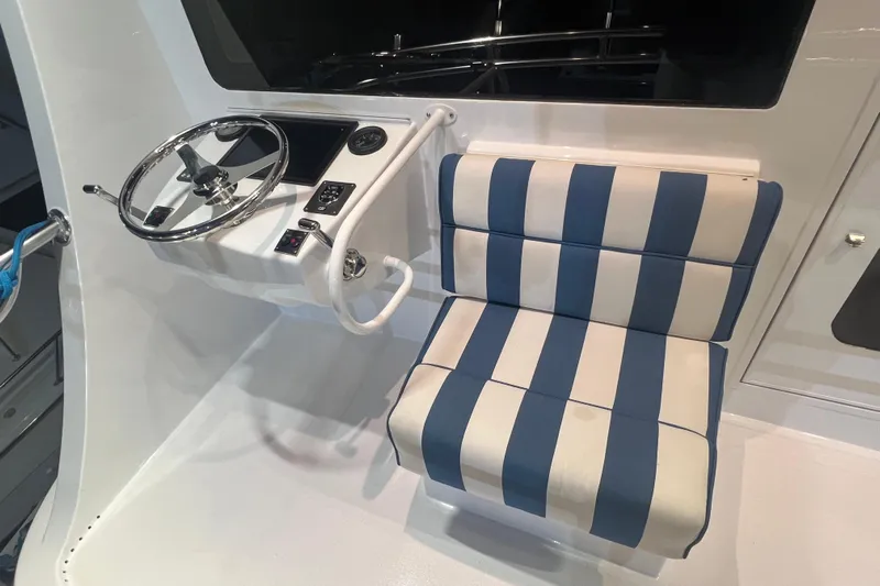 Sixpack Yacht Photos Pics Helm station of 2013 Hatteras GT63 with striped seat and steering wheel.