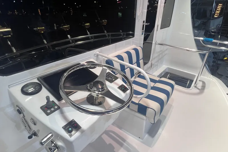 Sixpack Yacht Photos Pics 2013 Hatteras GT63 aft helm with striped seating and modern controls.