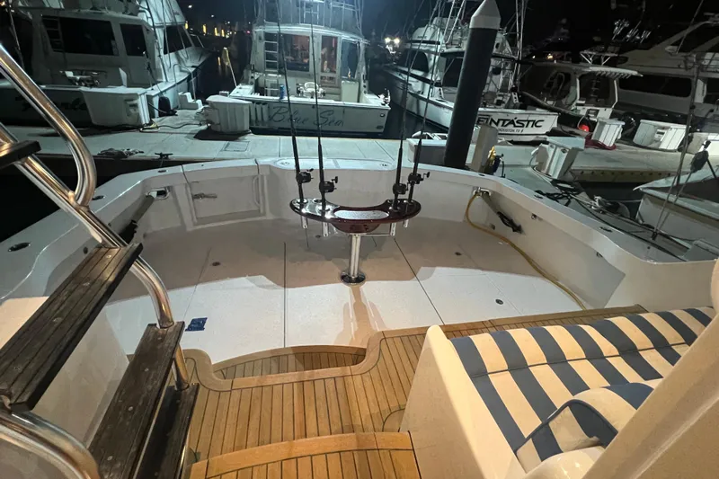 Sixpack Yacht Photos Pics 2013 Hatteras GT63 yacht deck at night, docked with fishing rods.