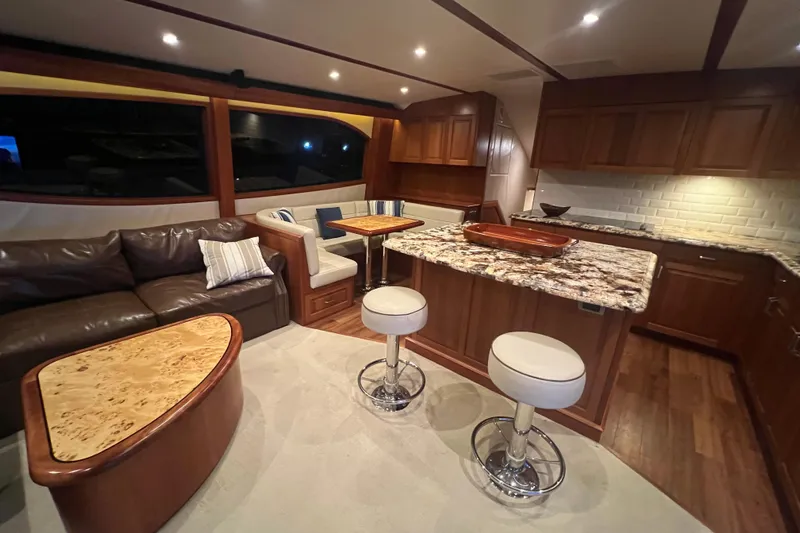 Sixpack Yacht Photos Pics Luxurious interior of 2013 Hatteras GT63 yacht with elegant seating and modern kitchen.