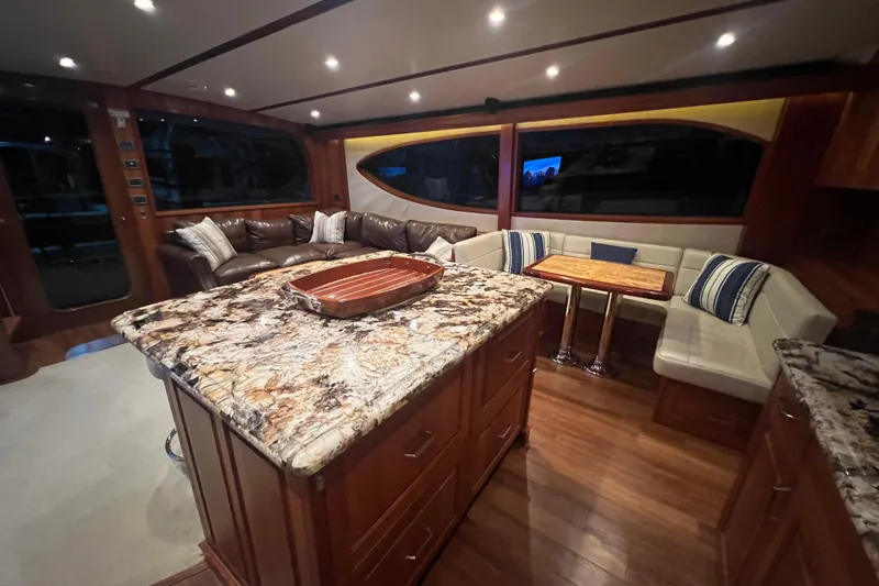 Sixpack Yacht Photos Pics Luxurious interior of 2013 Hatteras GT63 yacht with elegant seating and granite countertops.