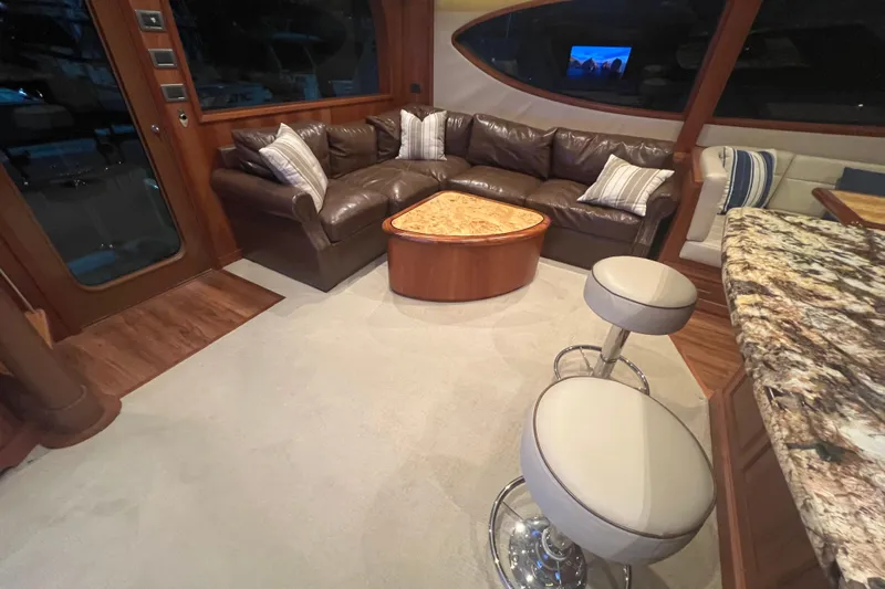 Sixpack Yacht Photos Pics Luxurious interior of 2013 Hatteras GT63 yacht with leather seating and elegant decor.