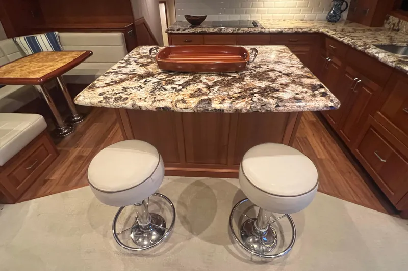 Sixpack Yacht Photos Pics Luxurious 2013 Hatteras GT63 yacht interior with granite countertops and modern seating.