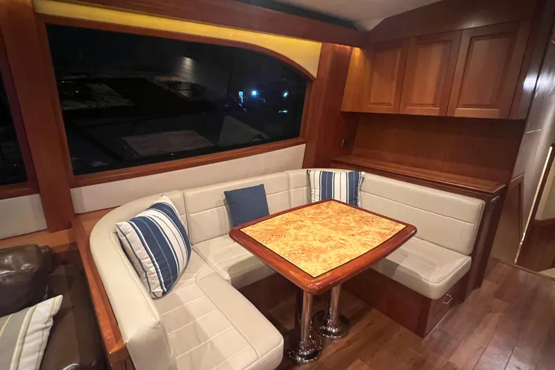 Sixpack Yacht Photos Pics Luxurious 2013 Hatteras GT63 yacht interior with elegant dining area and plush seating.