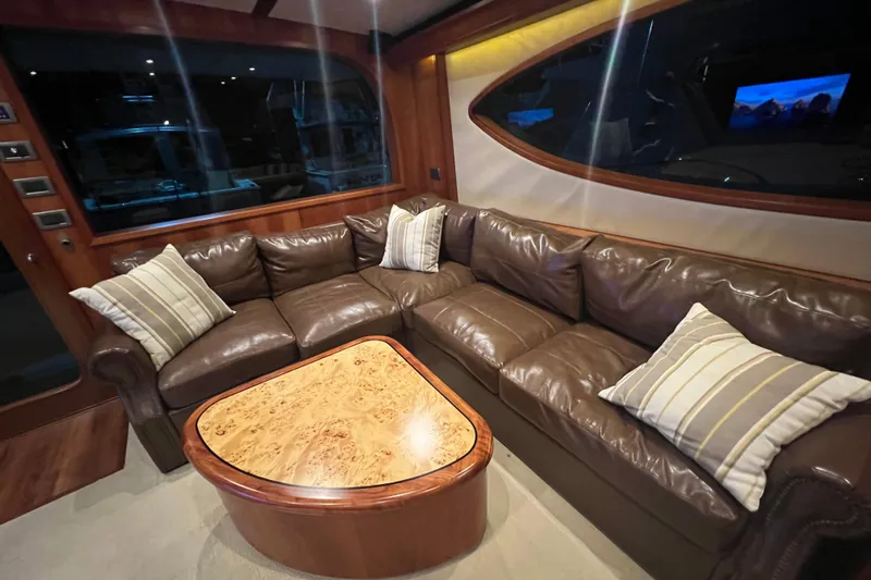 Sixpack Yacht Photos Pics Luxurious leather seating in 2013 Hatteras GT63 yacht interior with elegant wood accents.