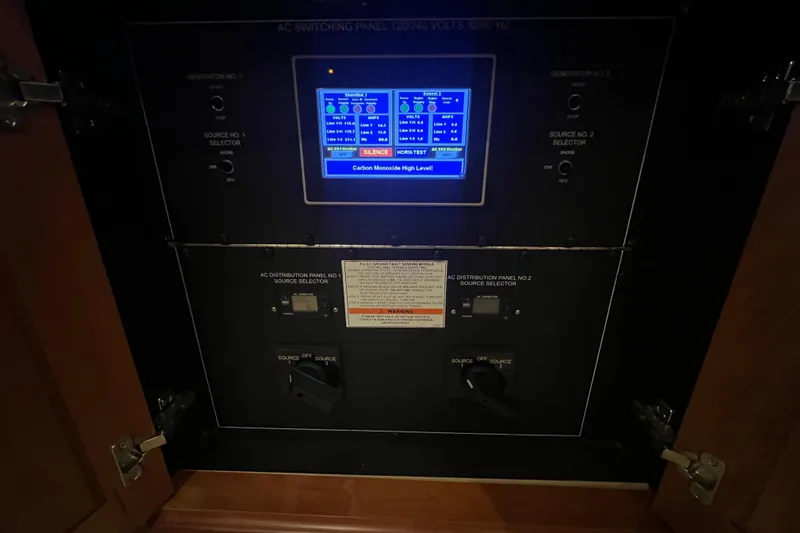 Sixpack Yacht Photos Pics Electrical control panel on a 2013 Hatteras GT63 yacht, displaying carbon monoxide alert.