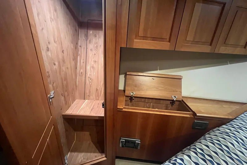 Sixpack Yacht Photos Pics Interior of 2013 Hatteras GT63 yacht with wooden cabinetry and storage compartments.