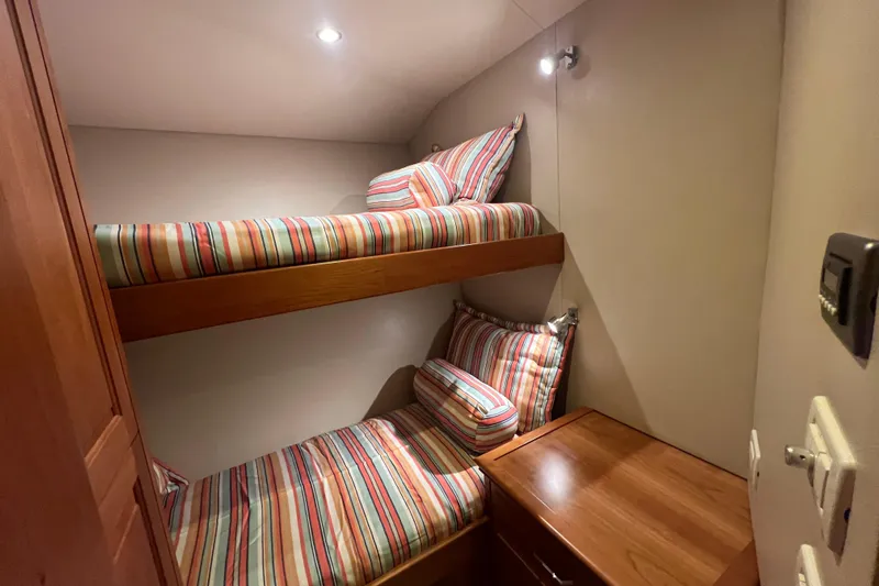 Sixpack Yacht Photos Pics Bunk beds with striped bedding in 2013 Hatteras GT63 yacht cabin.