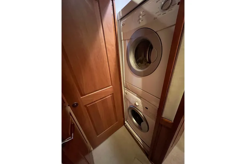 Sixpack Yacht Photos Pics Stacked washer and dryer in 2013 Hatteras GT63 yacht interior.