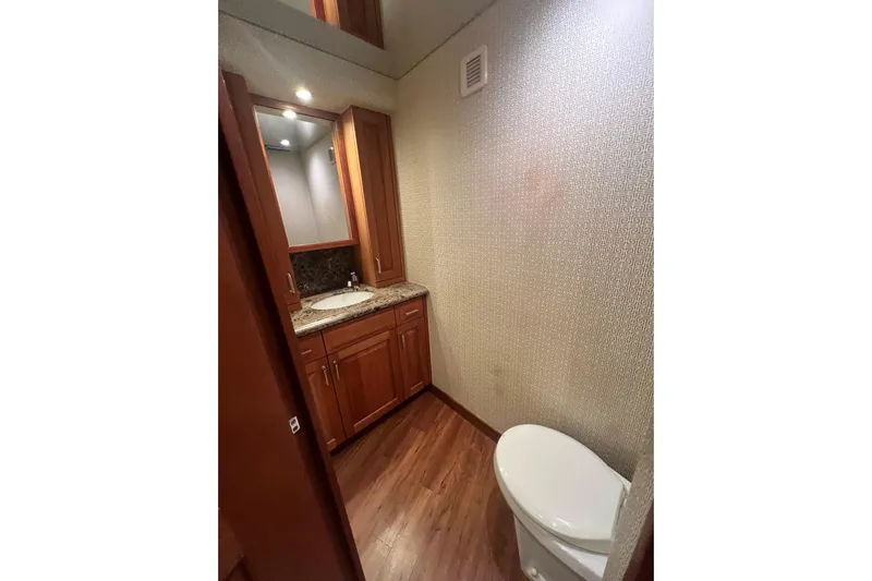 Sixpack Yacht Photos Pics Luxurious bathroom interior of 2013 Hatteras GT63 yacht with wooden cabinetry and modern fixtures.