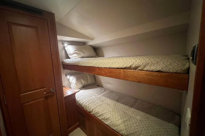 Sixpack Yacht Photos Pics Bunk beds in 2013 Hatteras GT63 yacht cabin with wooden finishes.