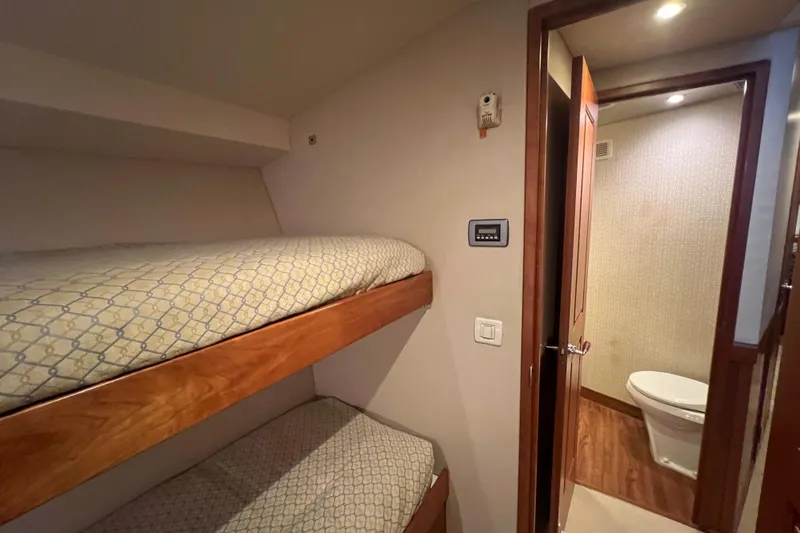 Sixpack Yacht Photos Pics Interior of 2013 Hatteras GT63 yacht with bunk beds and bathroom.