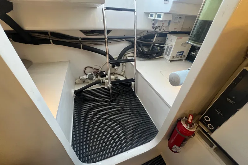 Sixpack Yacht Photos Pics Engine room of 2013 Hatteras GT63 yacht with equipment and fire extinguisher.