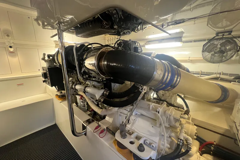 Sixpack Yacht Photos Pics Engine room of 2013 Hatteras GT63 yacht, showcasing powerful machinery and clean design.