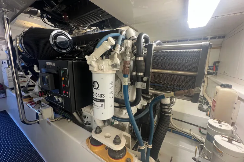 Sixpack Yacht Photos Pics Engine room of a 2013 Hatteras GT63 yacht featuring a Caterpillar engine.