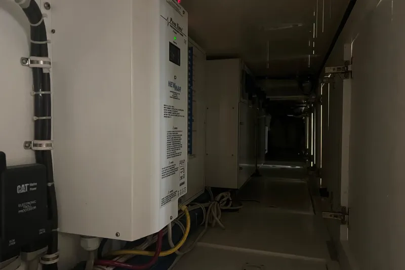 Sixpack Yacht Photos Pics Electrical compartment of a 2013 Hatteras GT63 yacht, featuring wiring and equipment.