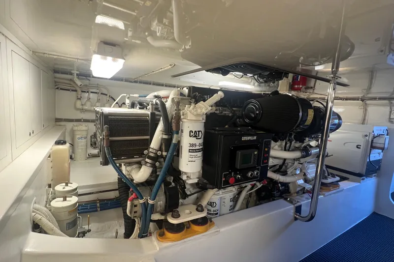 Sixpack Yacht Photos Pics Engine room of a 2013 Hatteras GT63 yacht, featuring a Caterpillar engine.